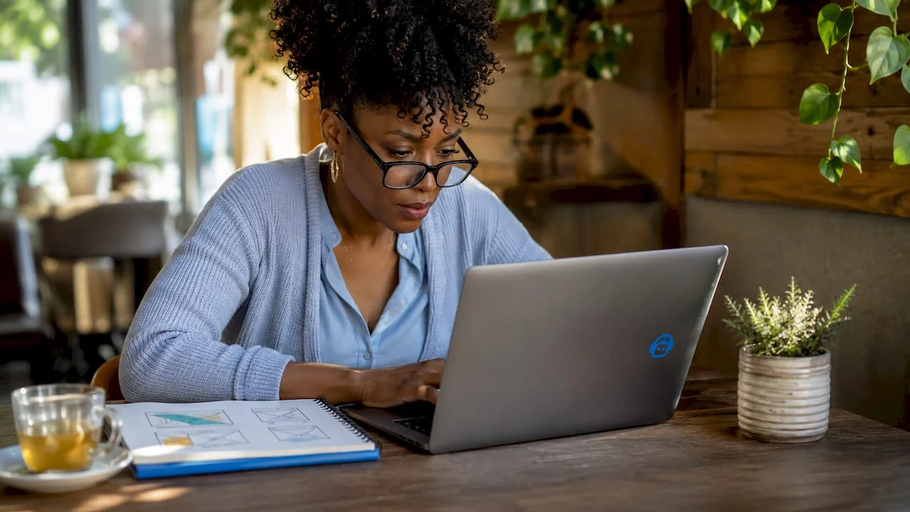 woman reviewing website trust elements at desk