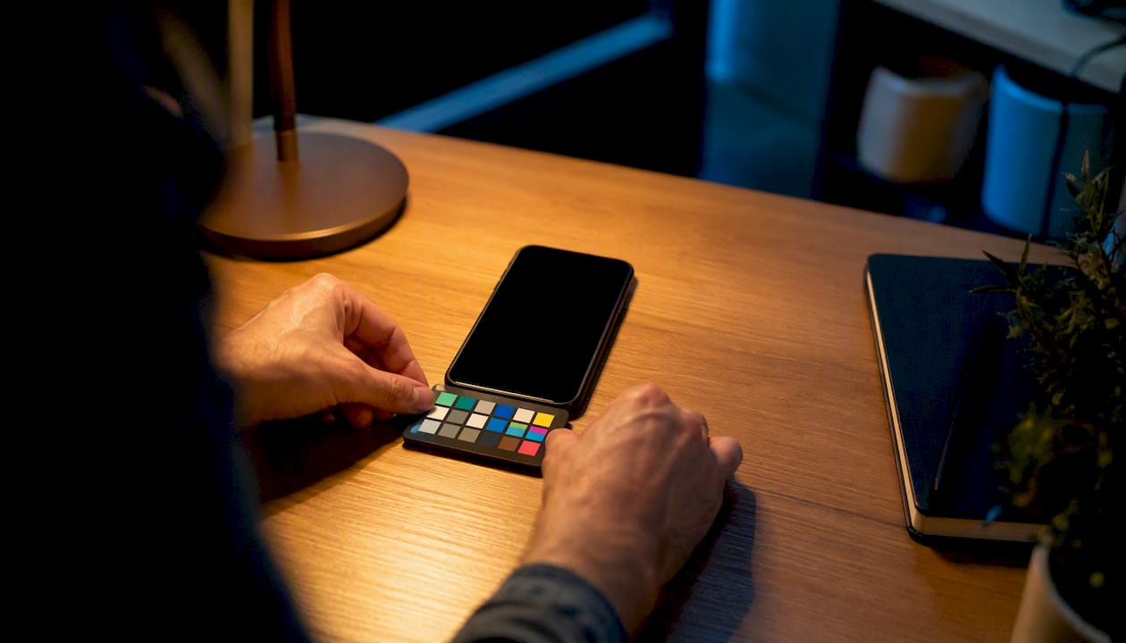 Hands placing calibration tool by smartphone