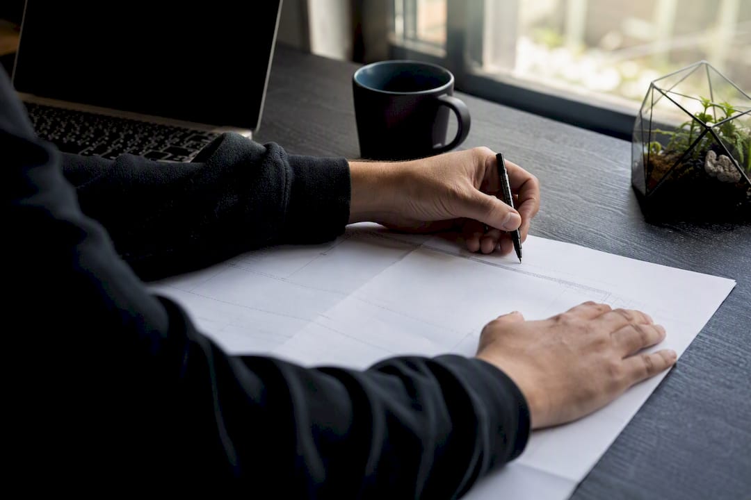 Hands auditing sitemap on desk