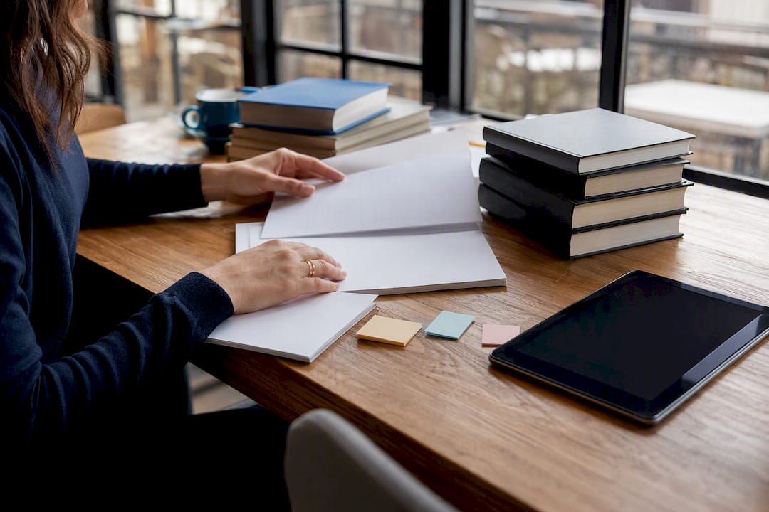 Hands arranging translator reference materials